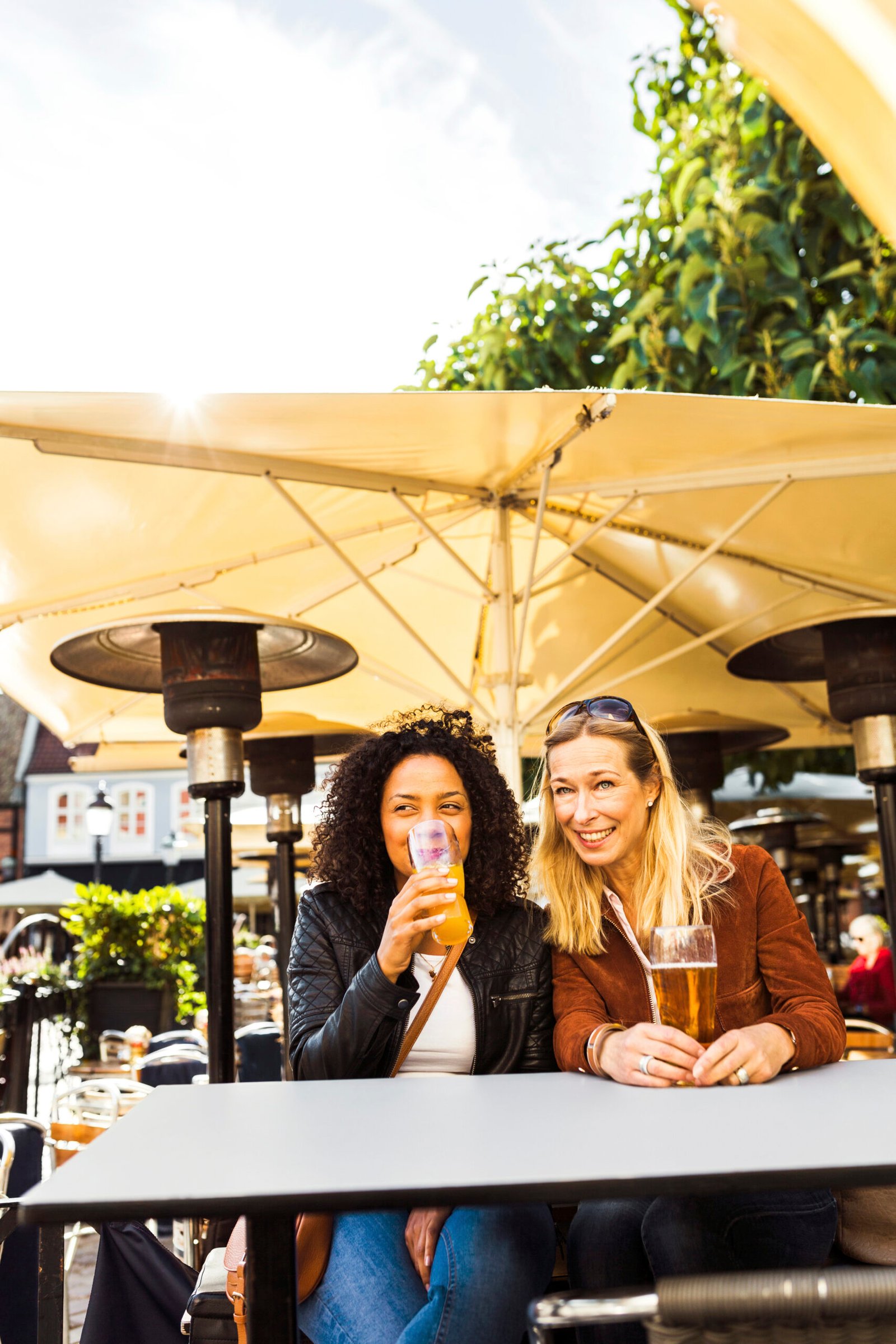 Two women having drinks in sidewalk cafe
